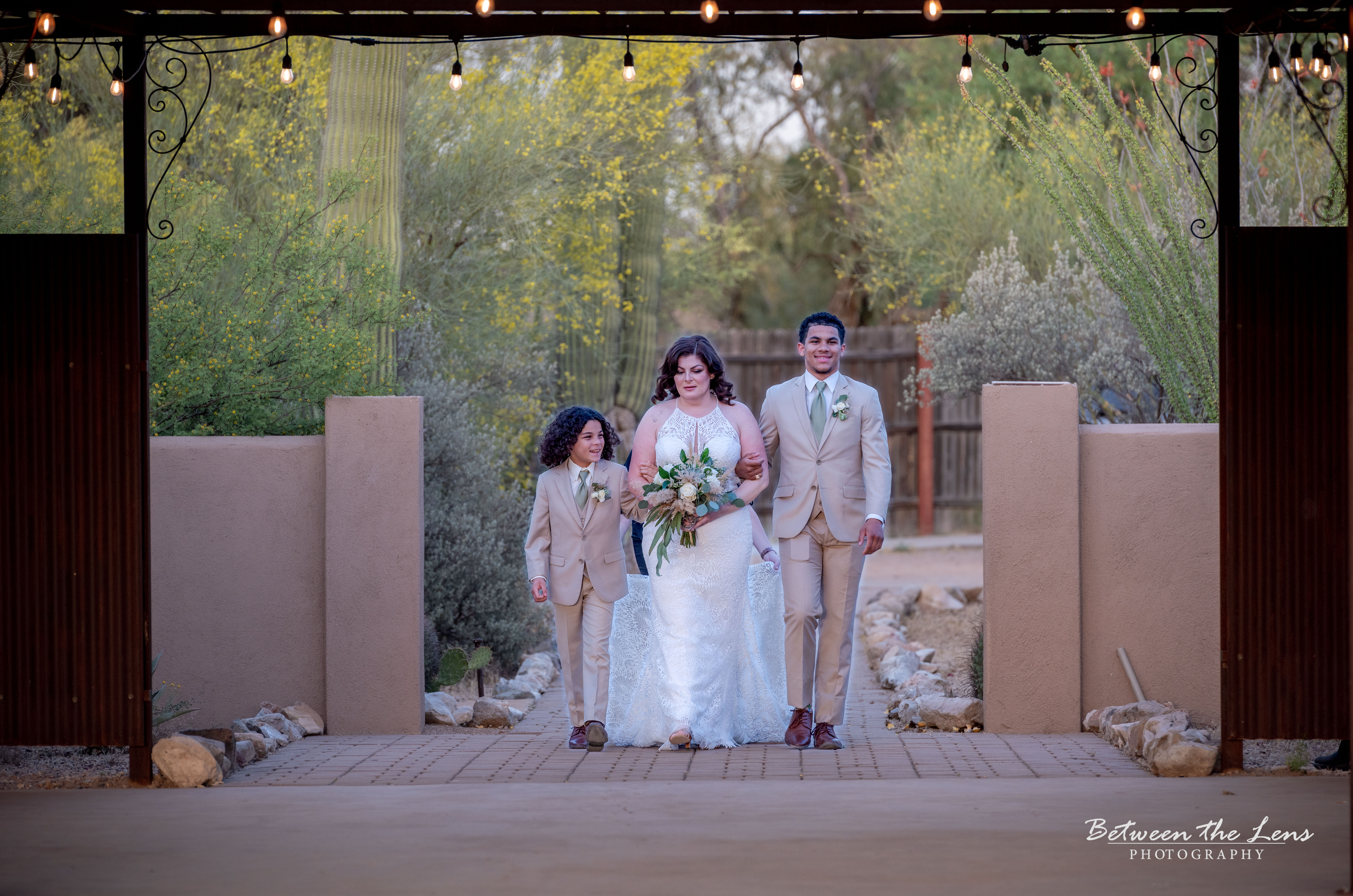 Bride being escorted down the aisle by two sons